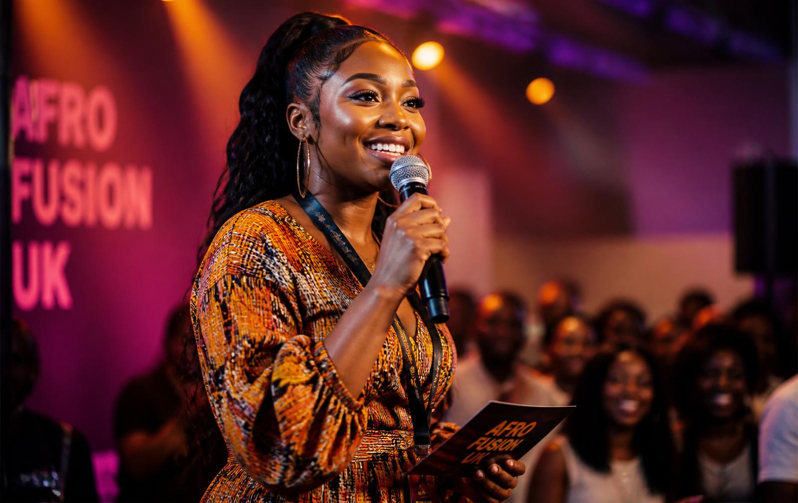 Event host on stage at an Afro fusion night